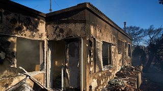 Smoke is seen inside a burned house as a wildfire burns in Rafina, east of Athens, Greece, Thursday, July 3, 2025, with several houses destroyed in the area.