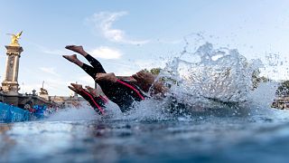 Competitors dive into the Seine river at the start of the men's 10km, marathon swimming, at the 2024 Summer Olympics, Friday, 9 August 2024, in Paris, France. 