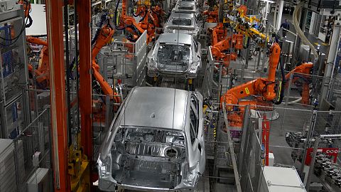 Robots work on cars of German car manufacturer BMW at an assembly line in Munich,