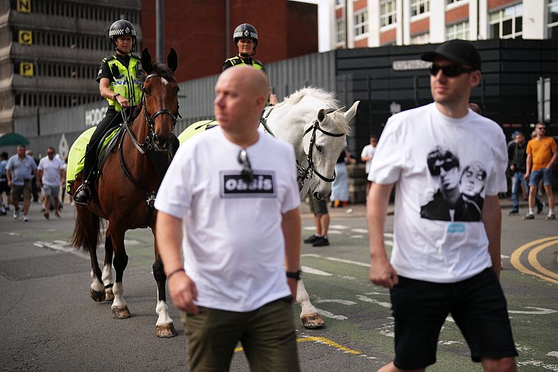 Oasis fans in Cardiff as police watch... 