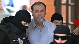 Juraj Cintula, center, is escorted to the Specialized Criminal Court in Banská Bystrica, Slovakia Tuesday, July 8, 2025