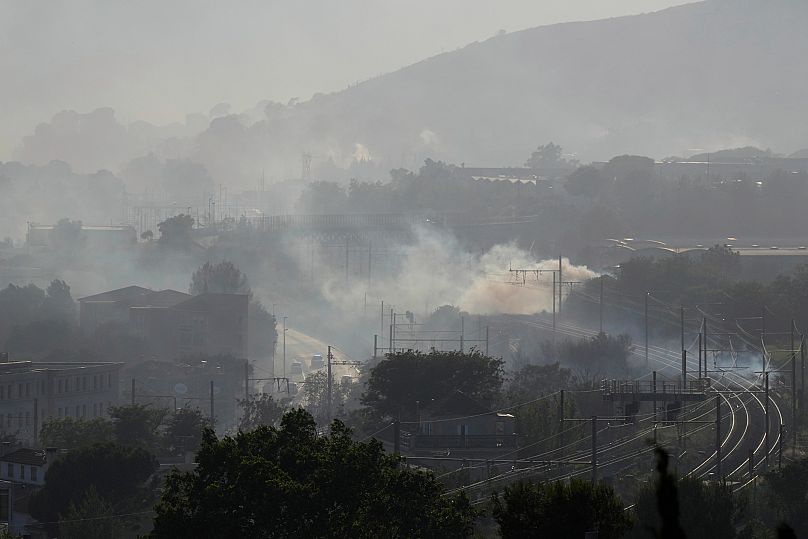 Smoke is seen by rail tracks during a wildfire Tuesday 8 July. 