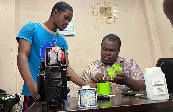 Le jeune innovateur sierra-léonais Oswald Dunda assemblant sa lampe dans son atelier. 