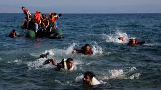 Migrants whose boat stalled while crossing from Turkey to Greece swim to the island of Lesbos, 20 September, 2015
