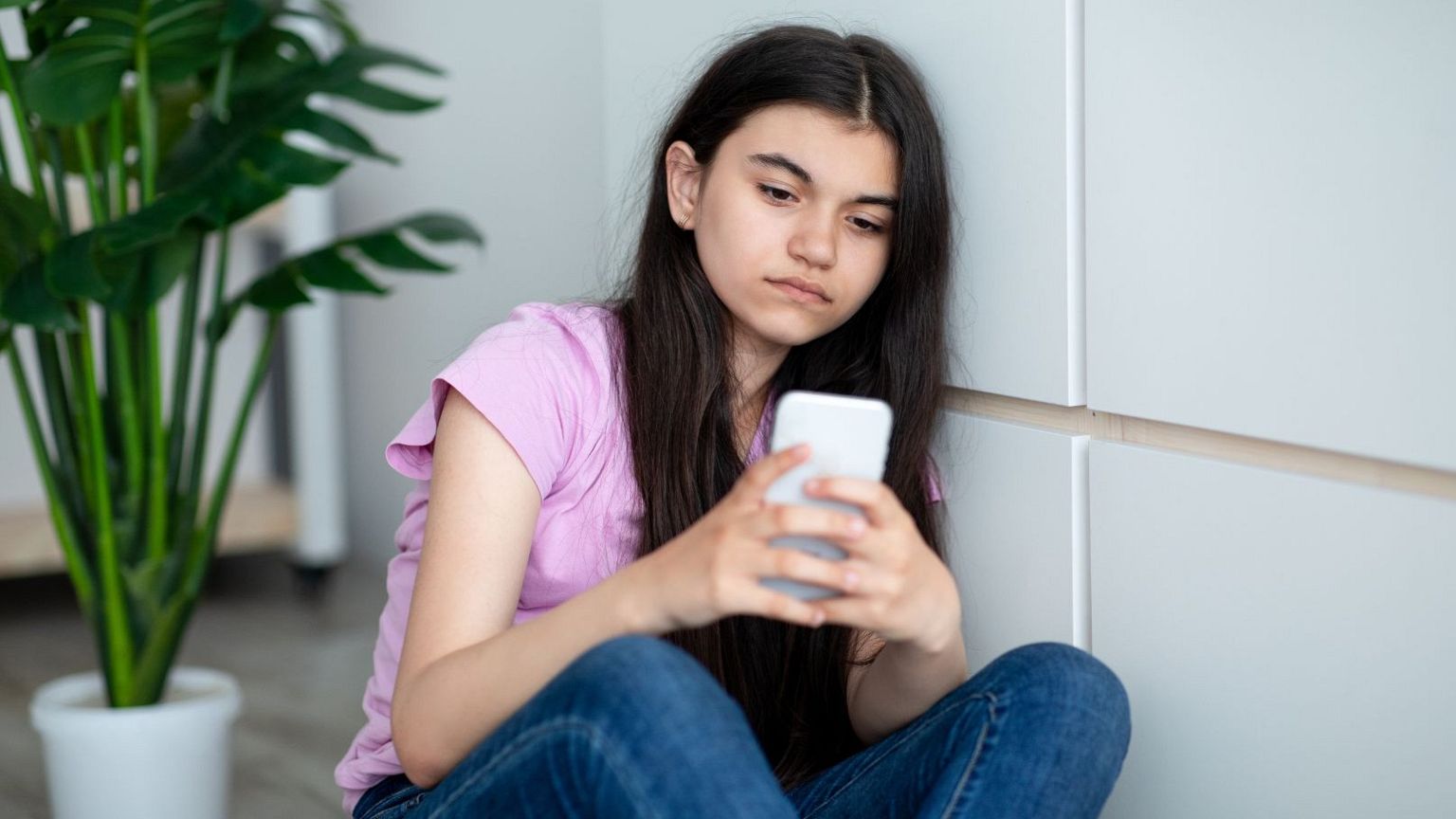 A teenage girl uses her mobile phone.