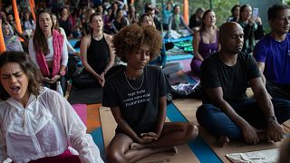 A woman sitting in the lotus position while meditating during a Transformation Project yoga class in the Rocinha favela, in Rio de Janeiro, Wednesday, July 9, 2025.