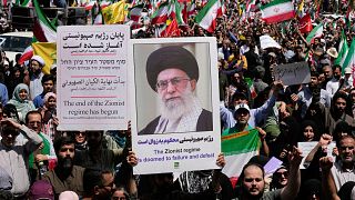 Iranian protestors carry portrait of the Supreme Leader Ayatollah Ali Khamenei and anti-Israeli signs during a protest in Tehran, 20 June, 2025