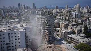 A building that was struck by an Iranian missile during the 12-day Israel-Iran war last month, is demolished in Bat Yam, Israel, Thursday, July 10, 2025.