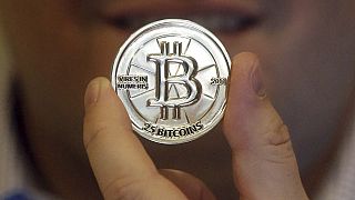 In this April 3, 2013 photo, a 25 Bitcoin token is displayed in Sandy, Utah. 