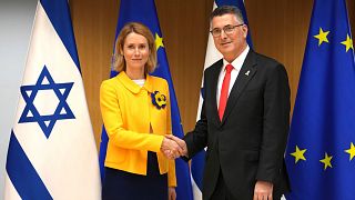 EU foreign policy chief Kaja Kallas, left, shakes hands with Israel's Foreign Minister Gideon Sa'ar during the EU-Israel Association Council at the European Counci
