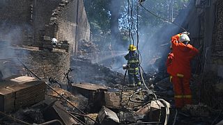 Emergency services personnel work to extinguish a fire following a Russian attack in Odesa, Ukraine, Friday, July 11, 2025