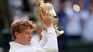 Jannik Sinner celebrates with the trophy after beating Carlos Alcaraz at Wimbledon, July 13 