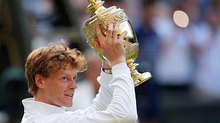 Jannik Sinner celebrates with the trophy after beating Carlos Alcaraz at Wimbledon, July 13 