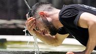 A worker refreshes at a fountain during a heatwave in Basel, Switzerland, on June 30, 2025. 