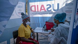 A nurse speaks with a patient who is HIV-positive inside a mobile clinic in Ngodwana, South Africa, in July 2020.