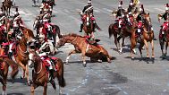 A horse slides on the pavement during the Bastille Day parade, Monday, July 14, 2025 in Paris.