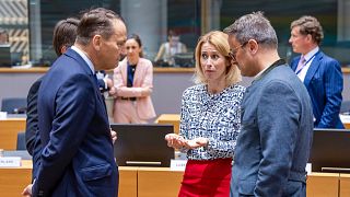 European Union foreign policy chief Kaja Kallas, center, talks with Poland's Foreign Minister Radoslaw Sikorski, left, and Luxembourg's Foreign Minister Xavier Bettel, right, 