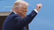 President Donald Trump gestures from the stairs of Air Force One as he boards upon his arrival at Joint Base Andrews, Md., 15 July, 2025. 