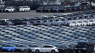 A car, center, is moved to another location of the area where export vehicles are parked at Daikoku Pier in Yokohama, near Tokyo, Tuesday, April 8, 2025