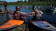 Kayakers pause before paddling the last couple of miles of the Klamath River to reach the Pacific Ocean on 11 July in Klamath, California. 
