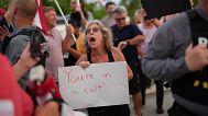 A woman shouts toward supporters of Trump as she participates in a pro-democracy, anti-Trump protest outside Trump's Mar-a-Lago estate in Palm Beach, July 17, 2025.