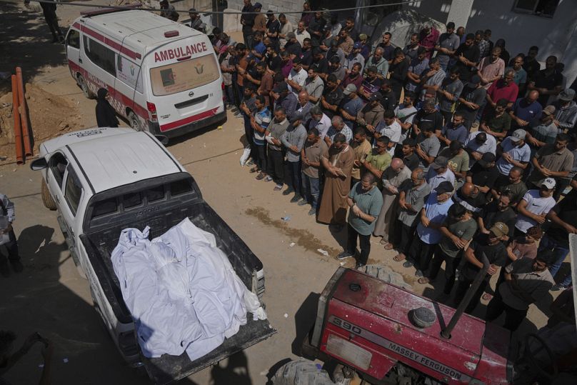 مشيعون يؤدّون الصلاة إلى جانب جثامين فلسطينيين قُتلوا في غارة جوية إسرائيلية، بمدينة غزة، 15 يوليو 2025.