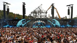 The burned main stage is seen as people listen to DJs Odymel and Pegassi performing at the Tomorrowland music festival in Boom, Belgium, Friday, July 18, 2025.