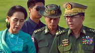 FILE - In this May 6, 2016, file photo, Aung San Suu Kyi, Myanmar's foreign minister, walks with senior General Min Aung Hlaing, Myanmar military chief, in Naypyitaw, Myanmar
