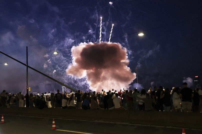 Fireworks explode near spectators during the final fireworks display of the Rhine Fair on Friday, July 18, 2025, in Düsseldorf