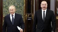 Russian President Vladimir Putin, left, and Azerbaijani President Ilham Aliyev enter a hall during a meeting at the Kremlin in Moscow, Russia, Oct. 8, 2024. 