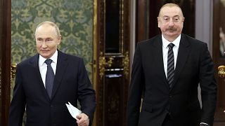 Russian President Vladimir Putin, left, and Azerbaijani President Ilham Aliyev enter a hall during a meeting at the Kremlin in Moscow, Russia, Oct. 8, 2024. 