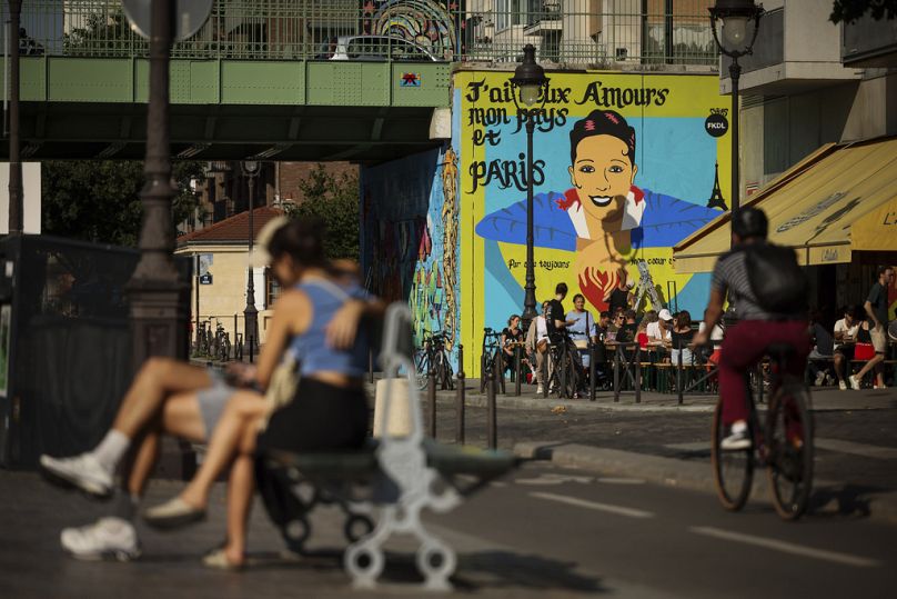 Artist Franck Duval, aka FKDL, works on a mural of U.S.-French entertainer and civil rights activist Josephine Baker