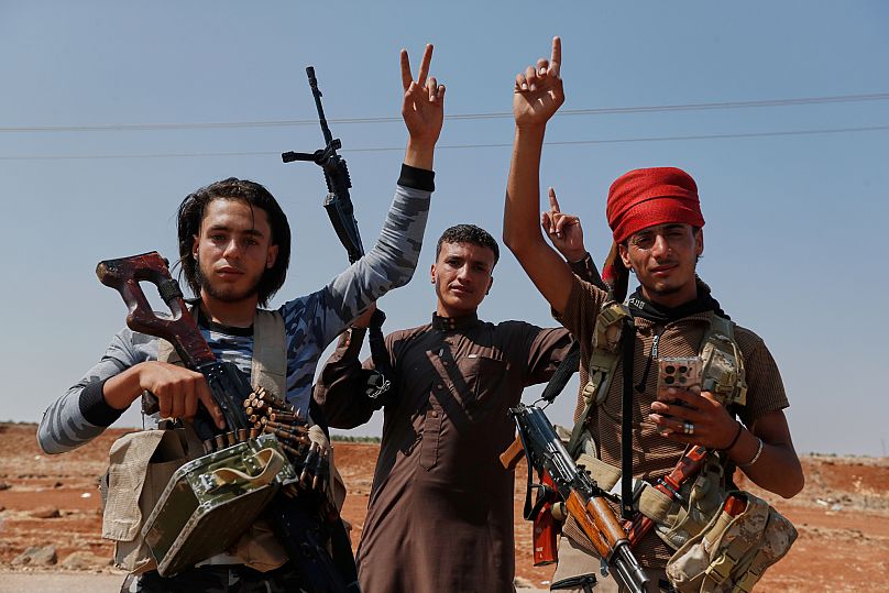 Bedouin fighters gesture as they gather in the village of Busra al-Harir, 22 July, 2025