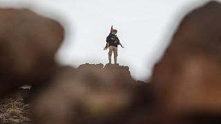 FILE: A fighter of the Druze Liwa al-Jabal militia guards on a hilltop near an outpost in Syria's southern province of Suwayda, 4 March 2025