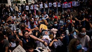 People listen to speeches during a protest in support of migrants without officials papers on hunger strike in Brussels, 17 July, 2021