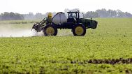 Spraying pesticides on a soya field