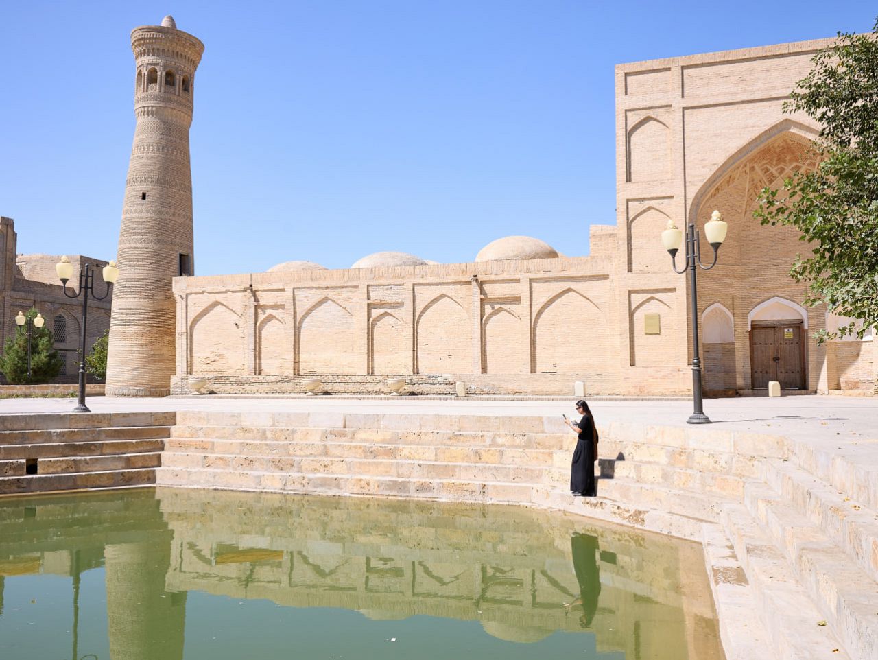 Artist Nomin Zezegmaa at the façade of the Khoja Kalon