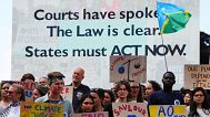 Activists demonstrate outside the International Court of Justice ahead of an advisory opinion.