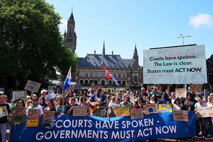 Activists demonstrate outside The Peace Palace, housing the International Court of Justice, ahead of the advisory opinion.