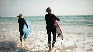 People Surfing On The Beach