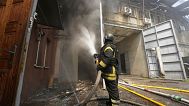 Firefighters tackle the blaze after a Russian attack that hit a residential area in Kharkiv