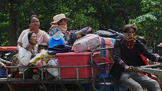 Cambodians sit on a tractor as they take refuge in Wat Tham Kambar in Oddar Meanchey province, Cambodia, Friday, July 25, 2025.