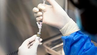 A pharmacist holds a vial of lenacapavir, the new HIV prevention injectable drug, at a clinic in South Africa in July 2024.