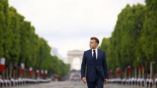 French President Emmanuel Macron arrives to the Bastille Day military parade on the Champs-Elysees avenue, 14 June 2025