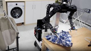 Images shows robot folding clothes