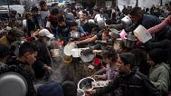 Palestinians line up for a meal in Rafah, 21 December, 2023