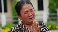 A local villager weeps as she donates her personal belongings for the frontline army force at a sidewalk in Srey Snam district in Siem Reap province, Cambodia, Saturday.