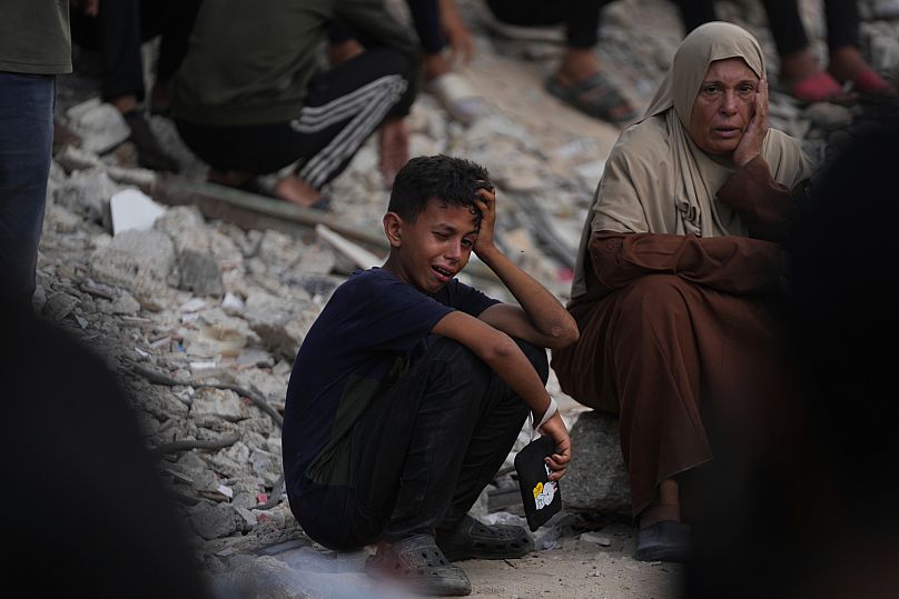 Palestinians mourn during the funeral of people who were killed while trying to reach aid trucks entering northern Gaza through the Zikim crossing with Israel, at Shifa Hospit