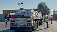 Trucks carrying humanitarian aids enter the Rafah crossing between Egypt and the Gaza Strip