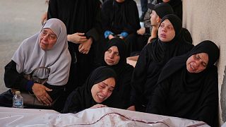 Palestinians mourn the 11 victims of an attack in Khan Younis